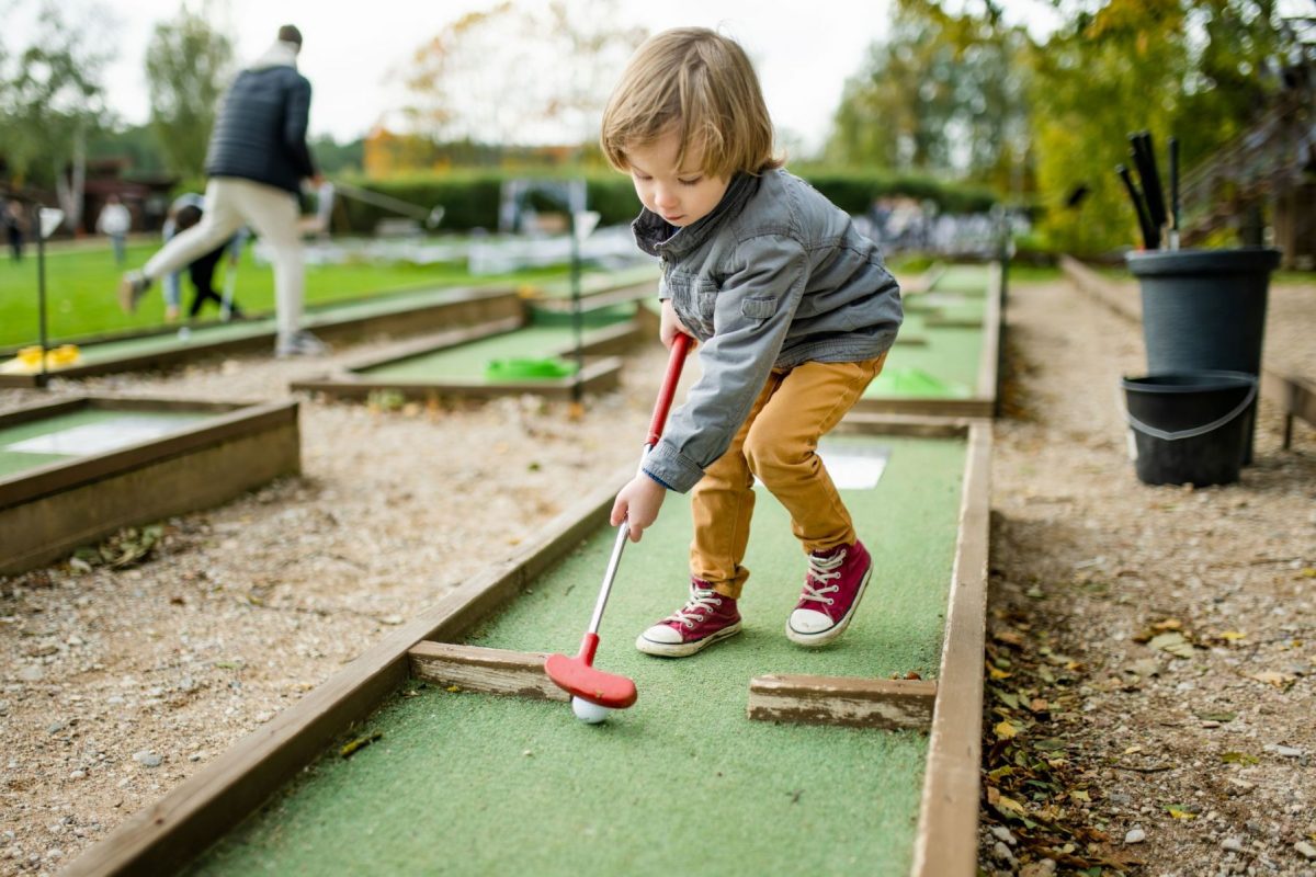 little boy playing mini golf on Marco Island